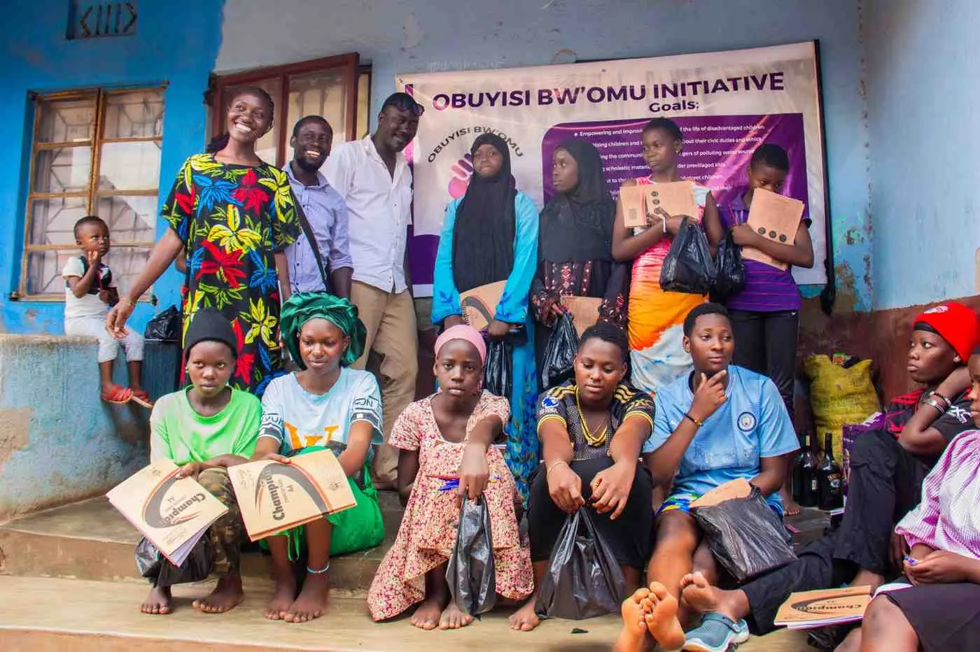 Girls and young women gathered with Obuyisi bw'Omu Initiative volunteers during a Flow with Dignity outreach