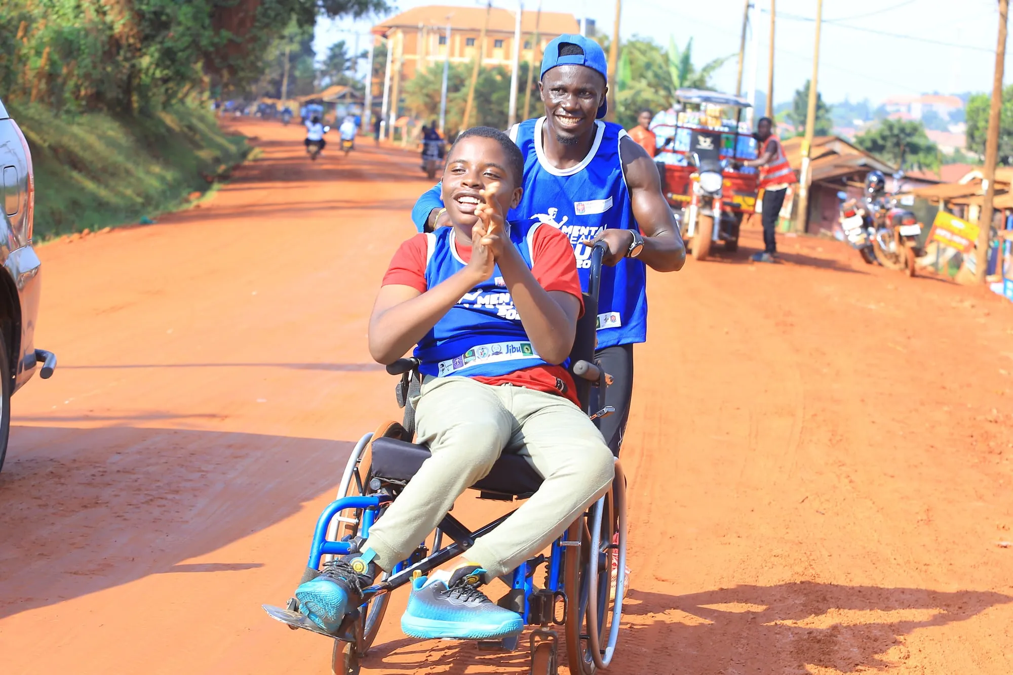 A young participant in a wheelchair celebrating during the Mental Health Run