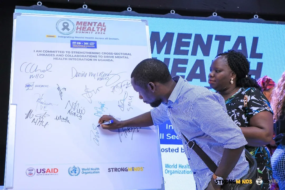 Signing the commitment board at the Mental Health Summit 2024