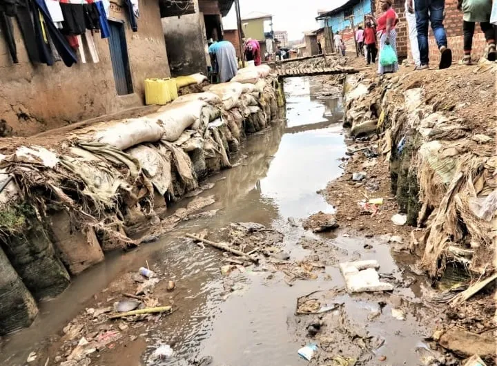 A drainage channel in Bwaise blocked with waste